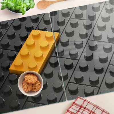 Sklenená doska na krájanie LEGO kocky na čiernom pozadí