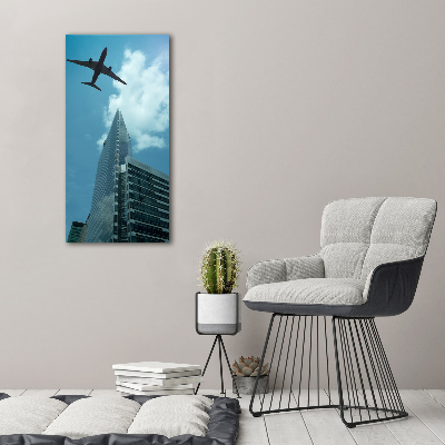 Vertikálny foto obraz fotografie na skle Lietadlo nad mestom