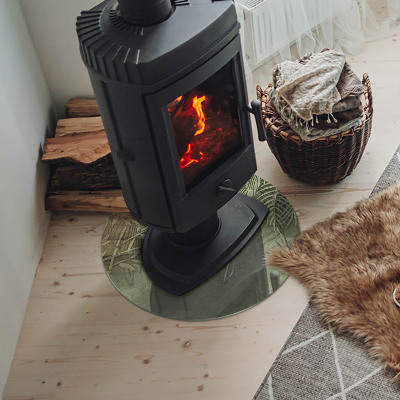 Okrúhla sklenená podložka pod krb Tropické listy na pozadí