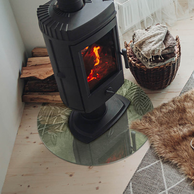 Okrúhla sklenená podložka pod krb Tropické listy na pozadí