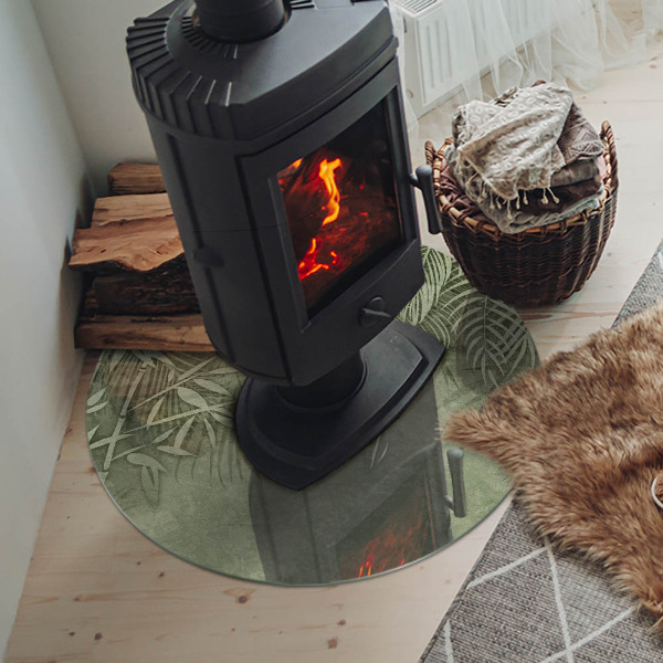 Okrúhla sklenená podložka pod krb Tropické listy na pozadí